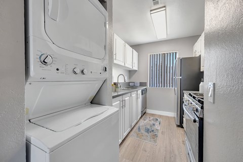 a laundry room with a washer and dryer in a kitchen