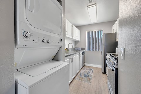 a laundry room with a washer and dryer in a kitchen