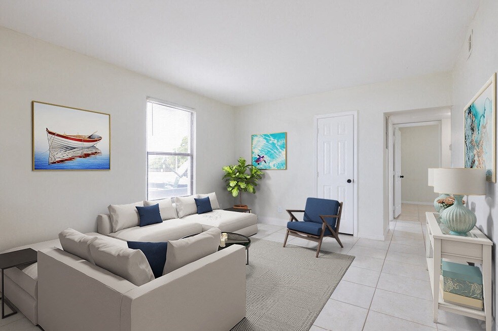 a living room with a white couch and a blue chair