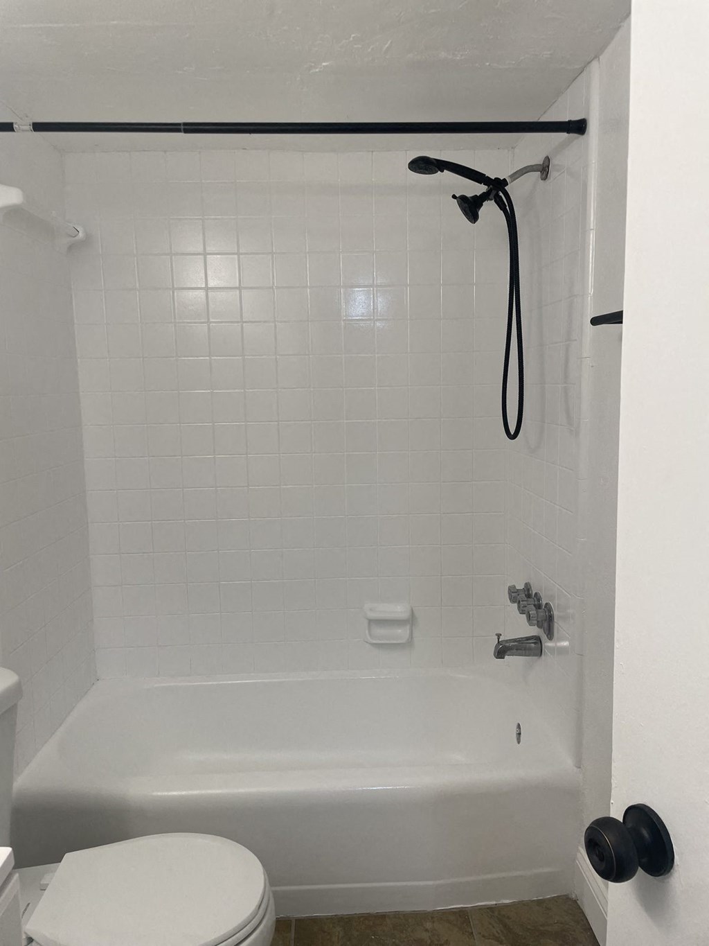 bathroom tub with black hardware