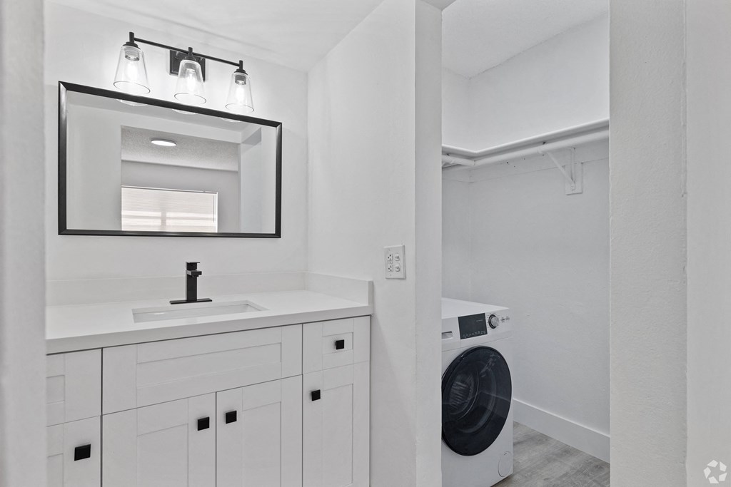 a bathroom with a sink and a washer and dryer