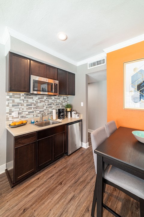 a kitchen and dining room with a table and a sink