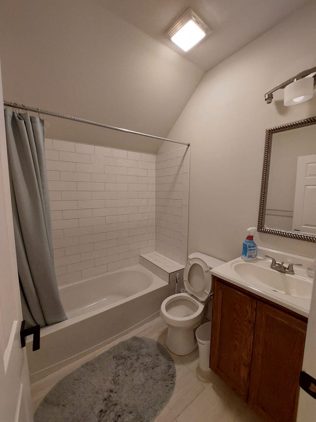 A bathroom with a toilet, sink, and bathtub.
