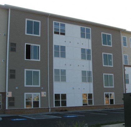 Apartment building with grey and white exterior.