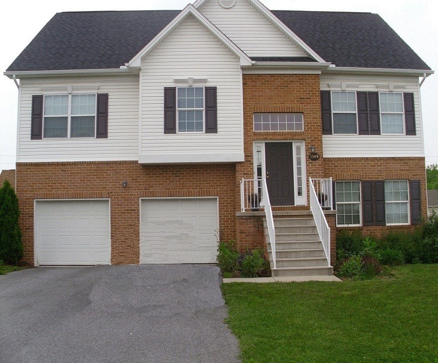 a house with two garages in front of it