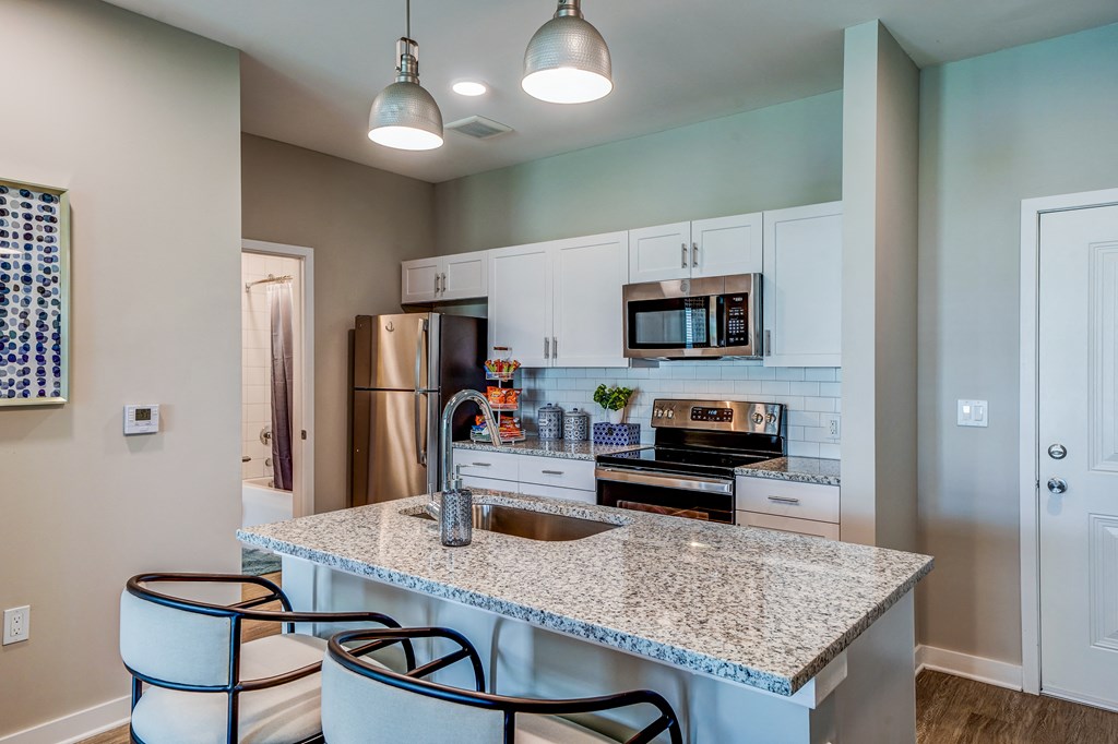a kitchen with granite counter tops and stainless steel appliances