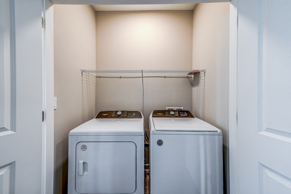 two washers and dryers in a laundry room