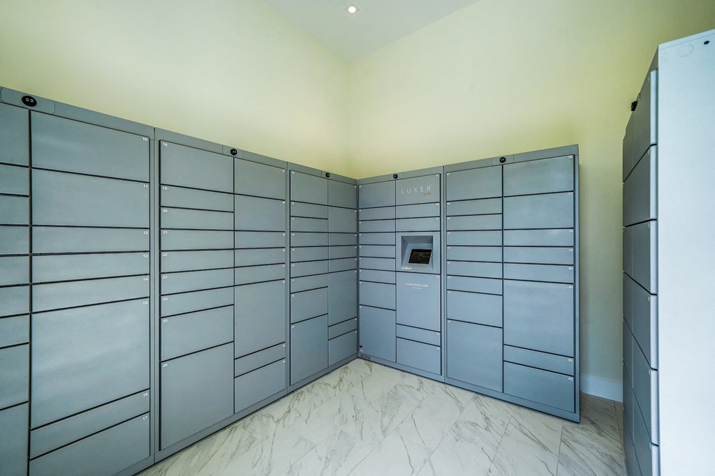 a large storage room with large metal lockers and a refrigerator