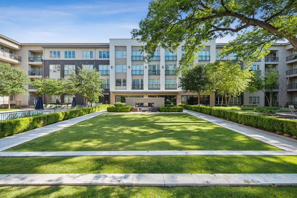 a view of a garden with a building in the background