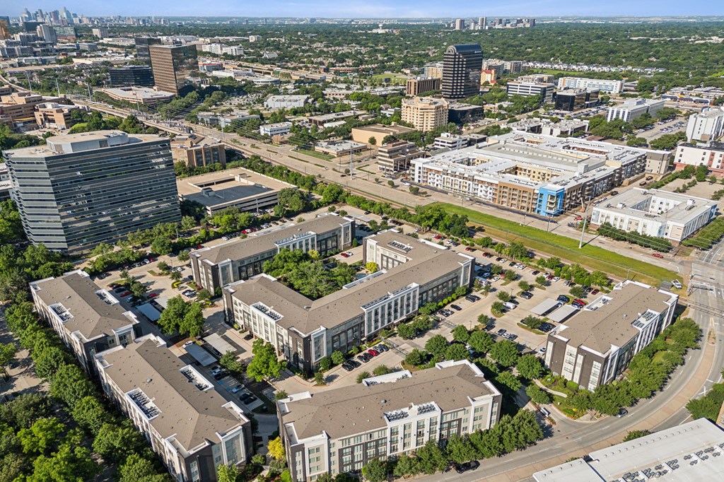 an aerial view of a city with buildings and trees