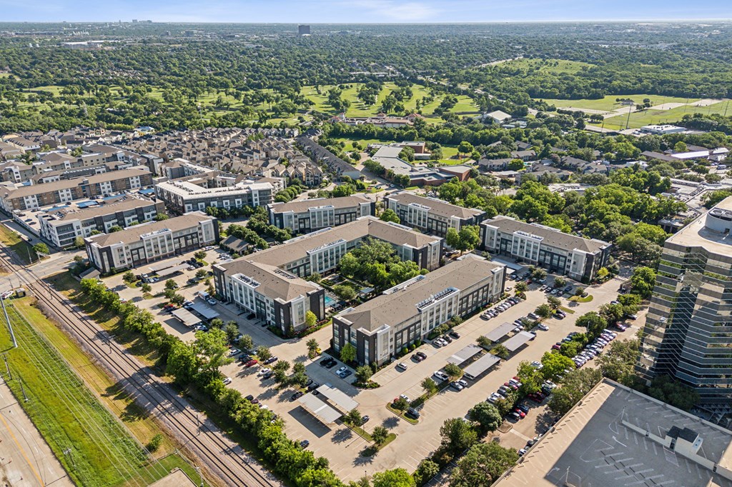an aerial view of a large building with many arches and trees