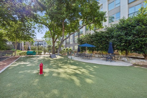 a courtyard with a red fire hydrant in front of an apartment building