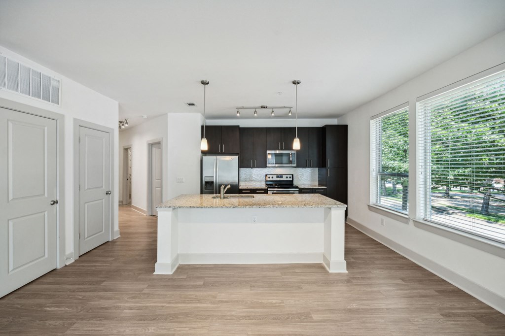 a kitchen with a large island and a large window