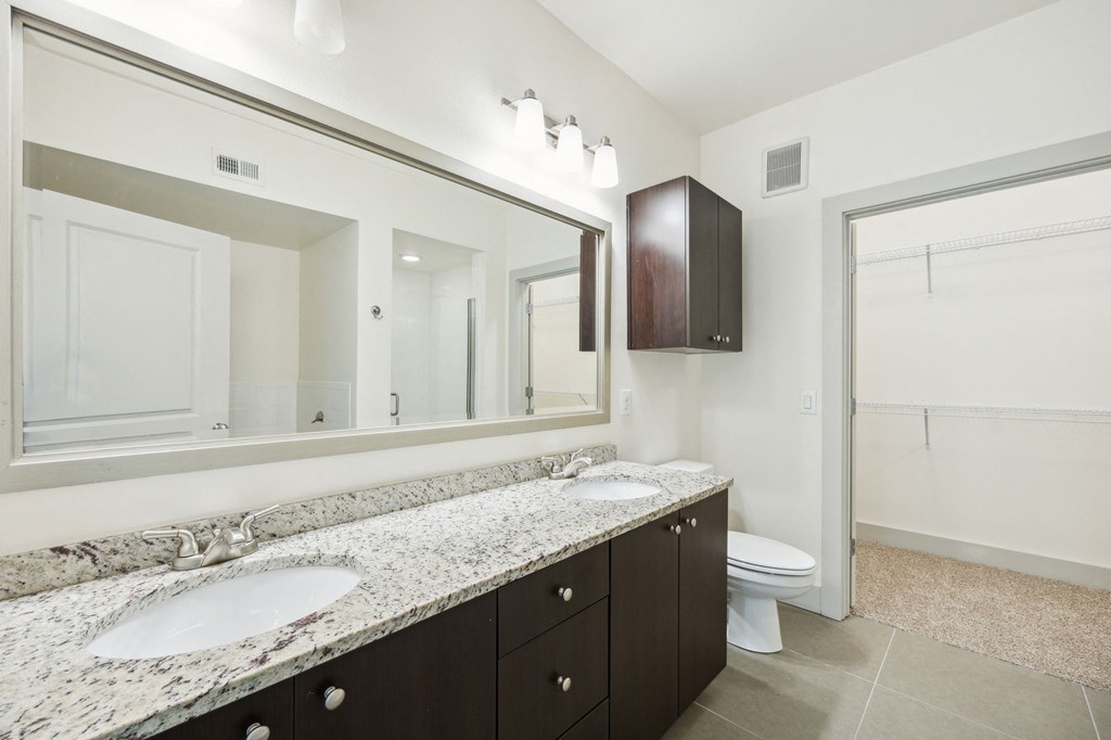 a bathroom with two sinks and a large mirror