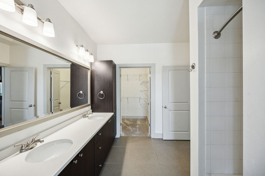 a bathroom with a large mirror and two sinks