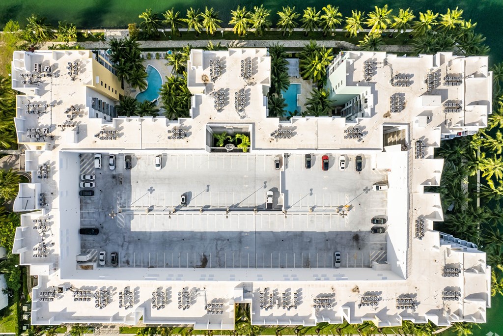 a birds eye view of the roof of a building with palm trees