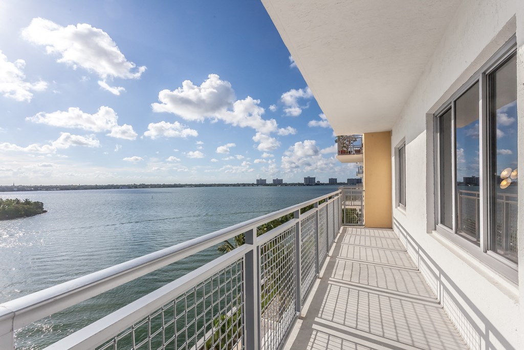 the view from the balcony of a condo overlooking the water