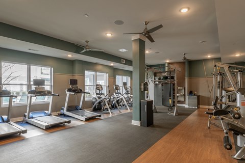 a fitness center with treadmills and other exercise equipment in a building