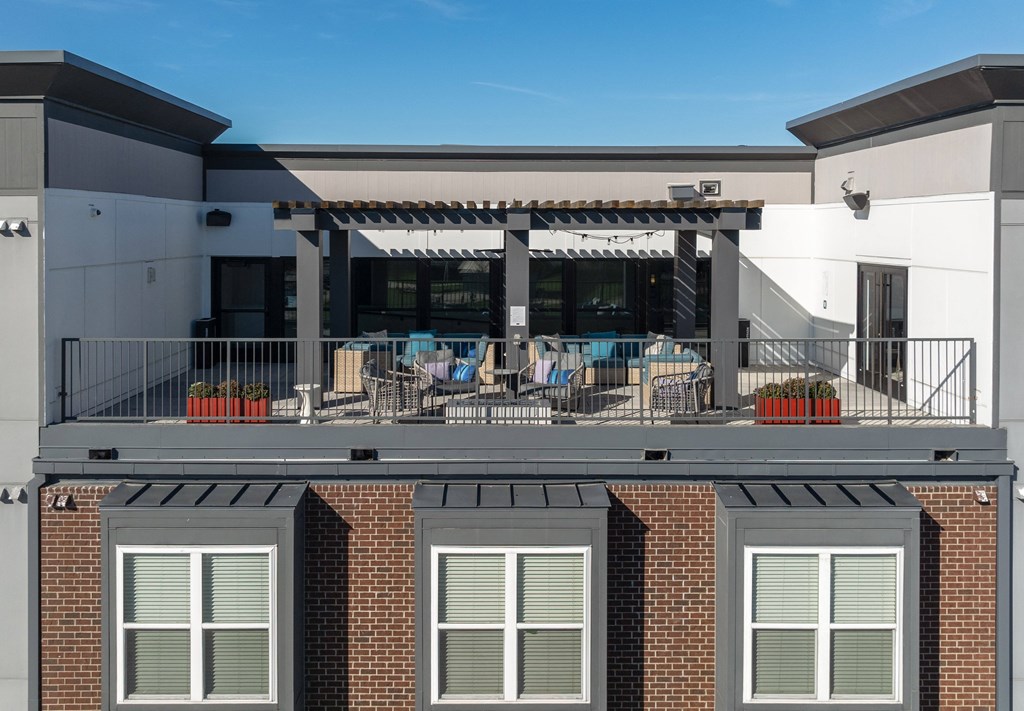 the upper deck of a building with tables and chairs