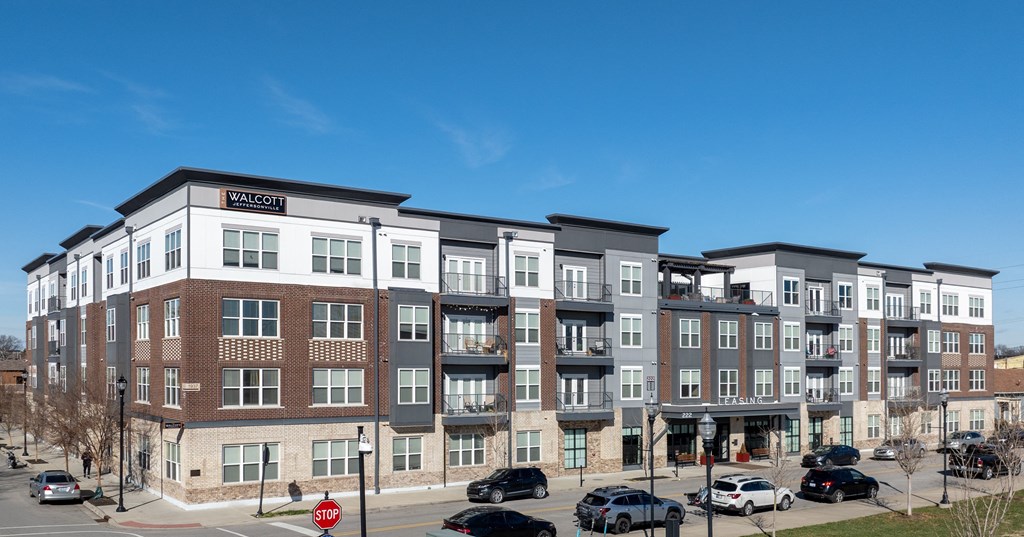 an exterior view of an apartment building on a city street