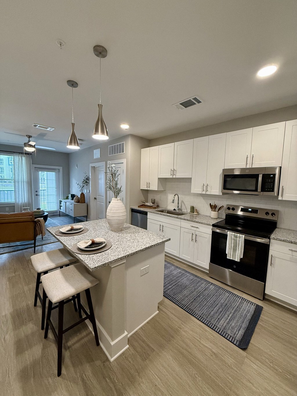 A kitchen with a white countertop and a stove top oven.