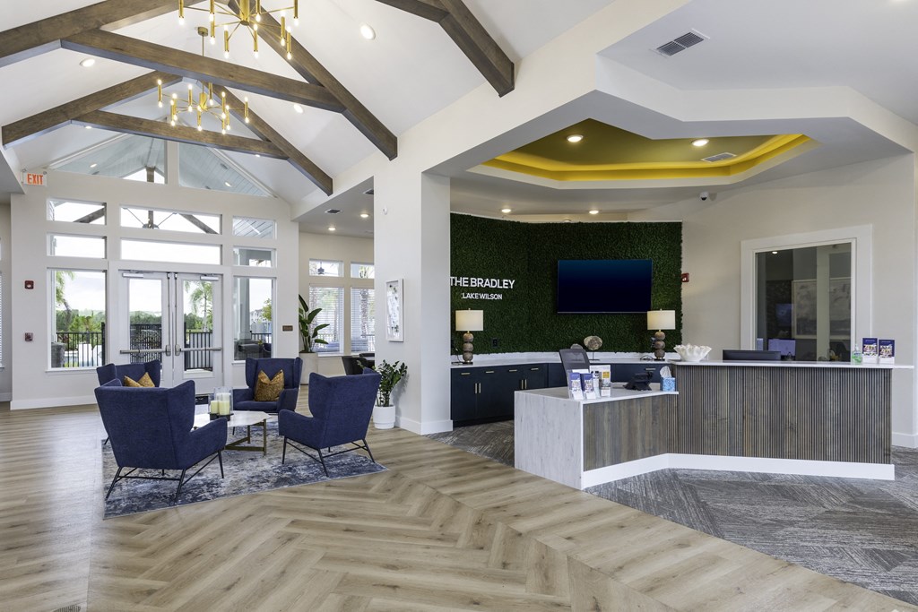 a lobby with a reception desk and chairs