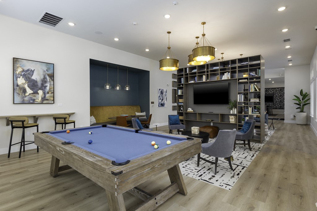 a clubhouse with a pool table and a tv