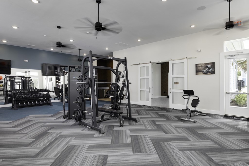 a home gym with exercise equipment and a chevron tile floor