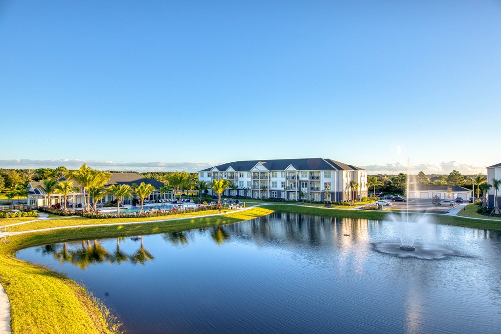 an aerial view of a lake with buildings and a fountain