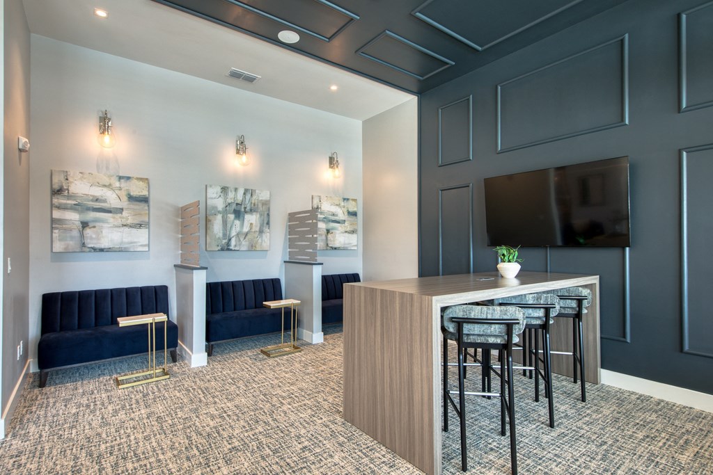 a communal area with a bar and a tv in a hotel room