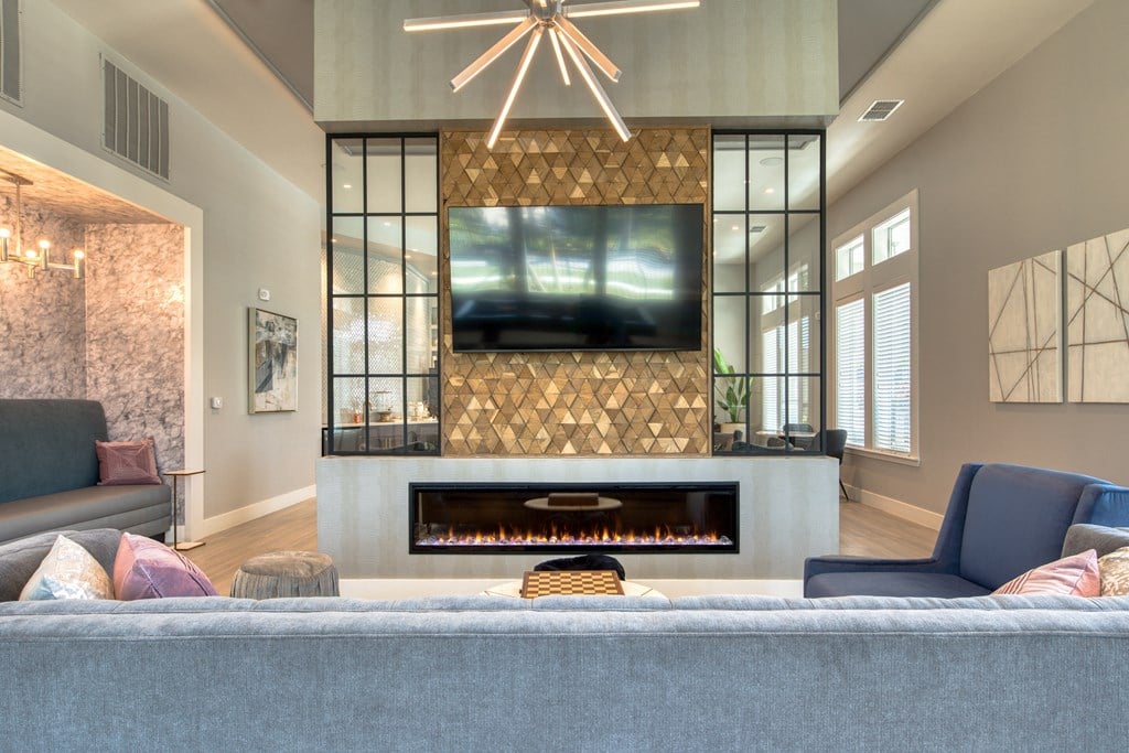 a living room with a fireplace and a tv