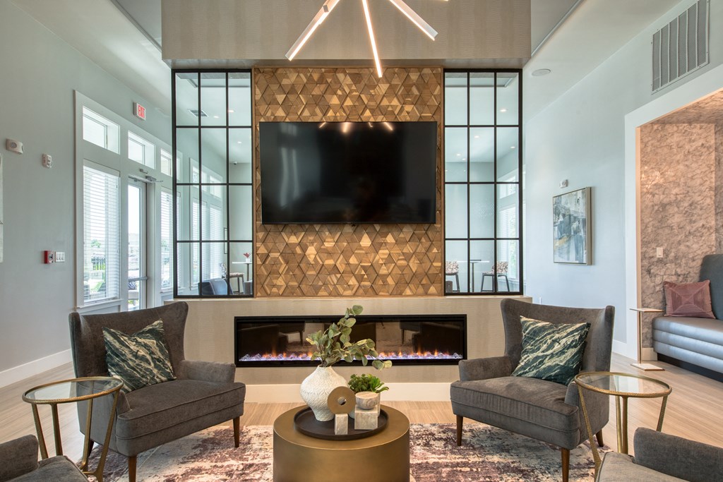 a living room with a fireplace and a tv above it
