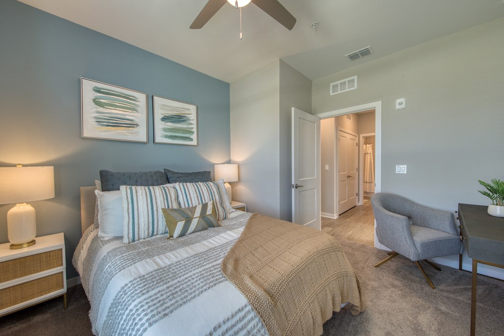 a bedroom with a large bed and a ceiling fan