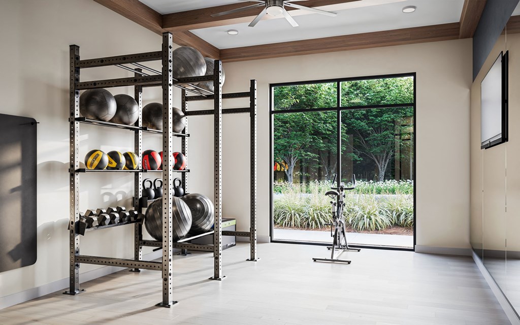 a fitness room with weights and a large window
