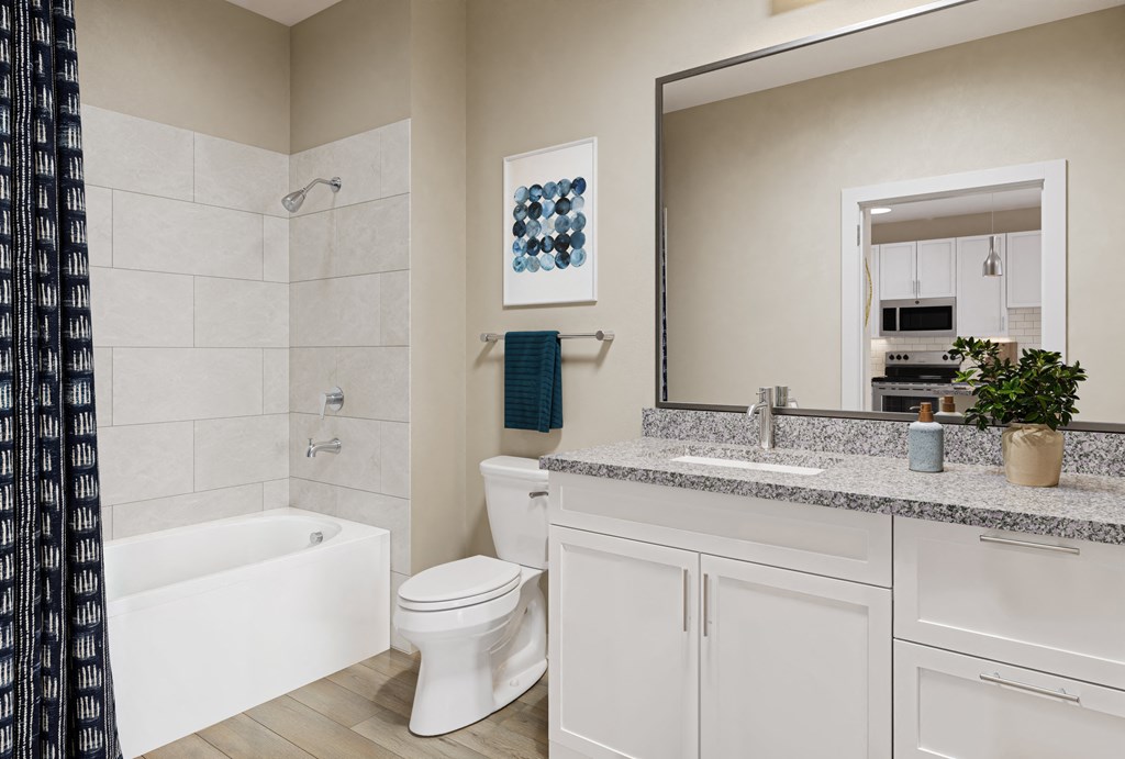 a bathroom with a large mirror and a toilet and a tub