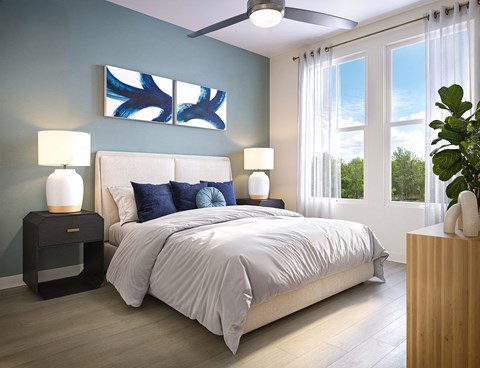 A bedroom with a bed, two lamps, and a painting on the wall.