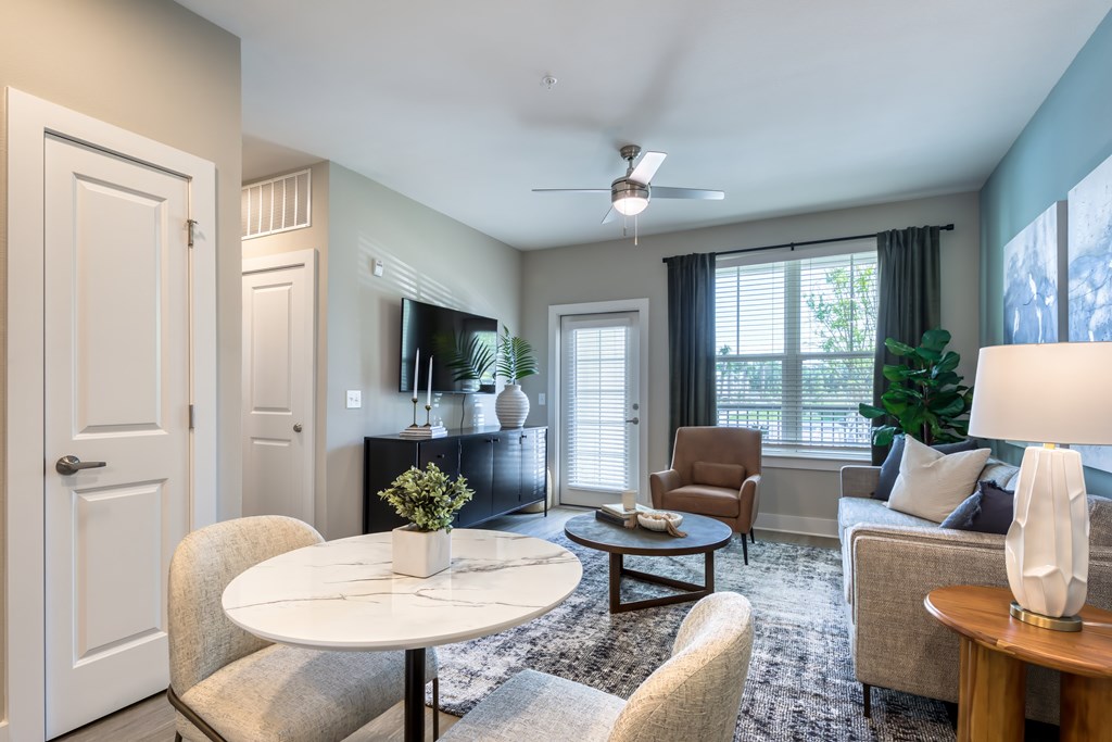 A living room with a white table and chairs.