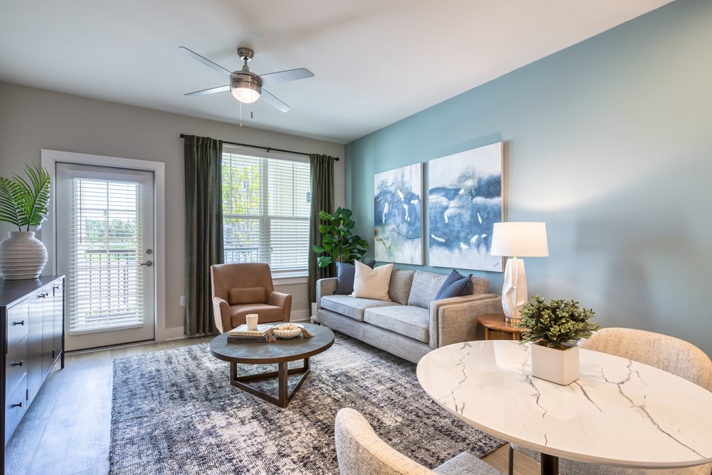 A living room with a white table and a brown chair.
