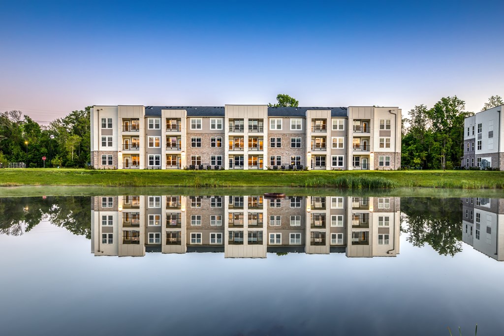 A building is reflected in the water in front of it.