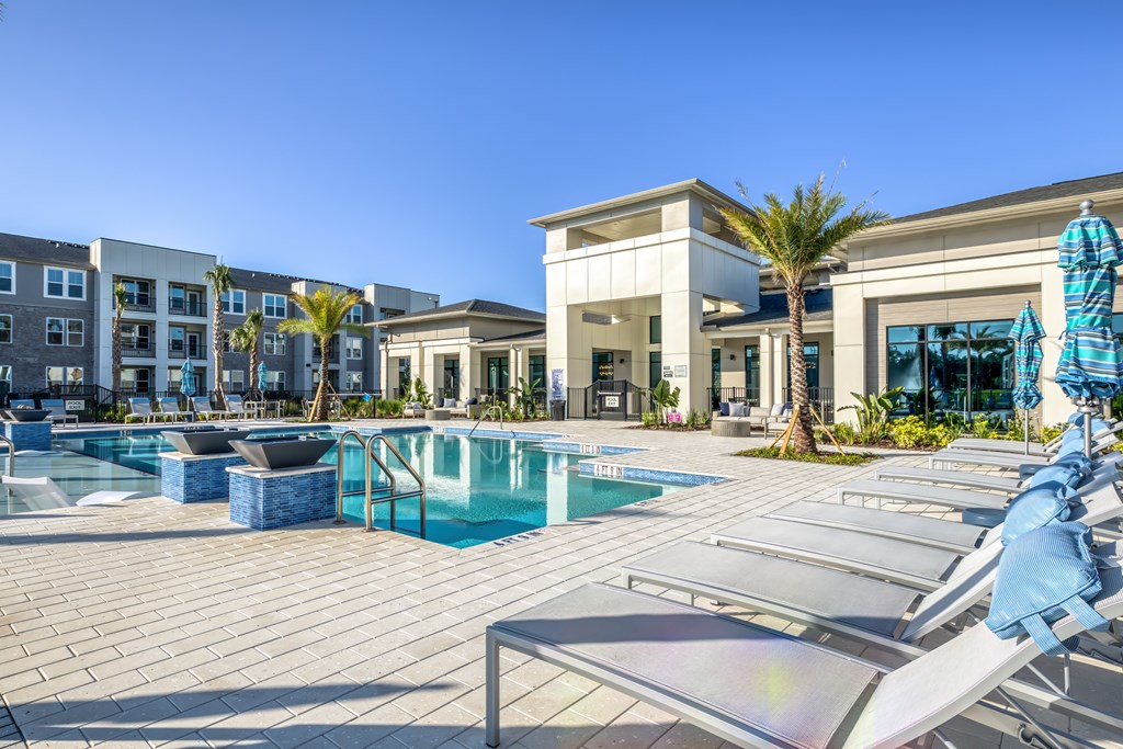 A sunny day at the poolside with a clear blue sky.