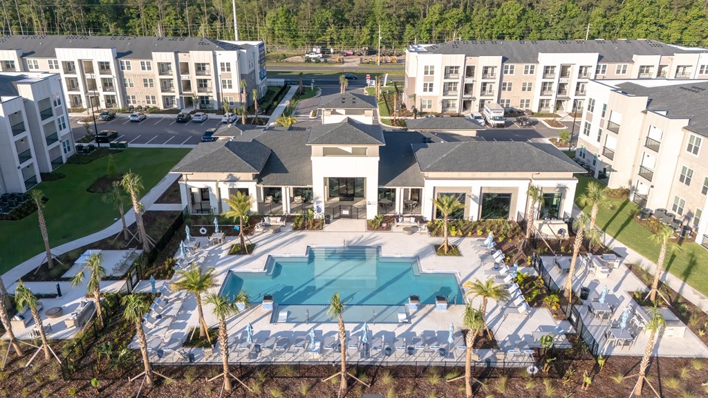 A large white building with a pool in front.