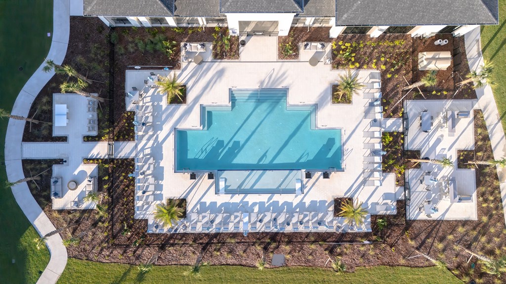 An aerial view of a house with a swimming pool in the backyard.