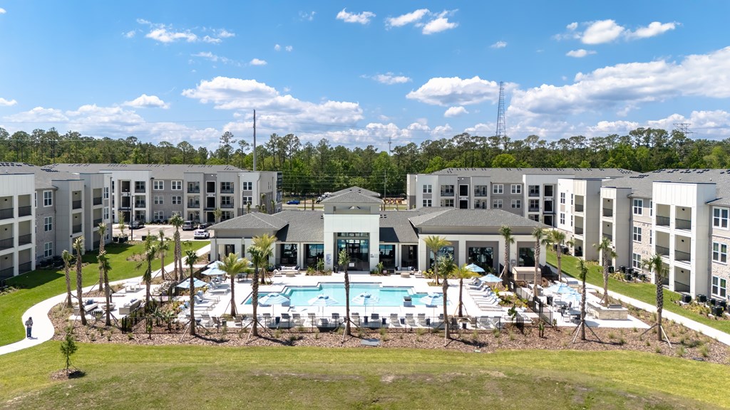 A large building complex with a pool in the middle.