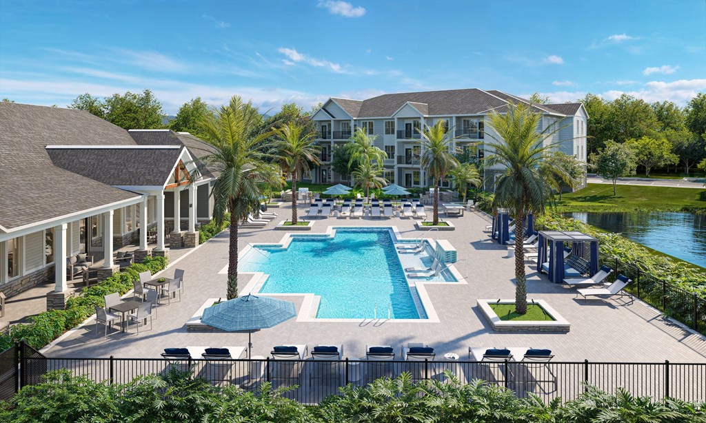 an aerial view of an outdoor pool with chairs and umbrellas at the resort
