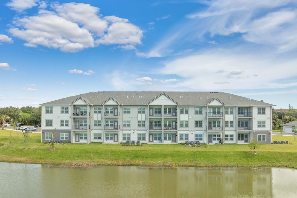 an image of an apartment building overlooking a lake