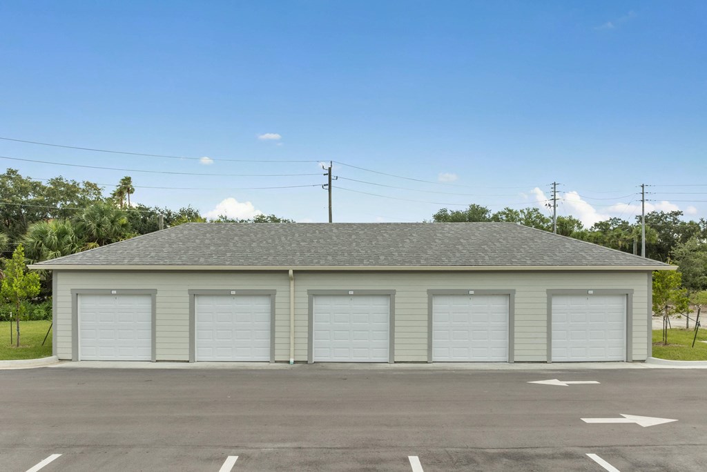 the front of a garage with white garage doors