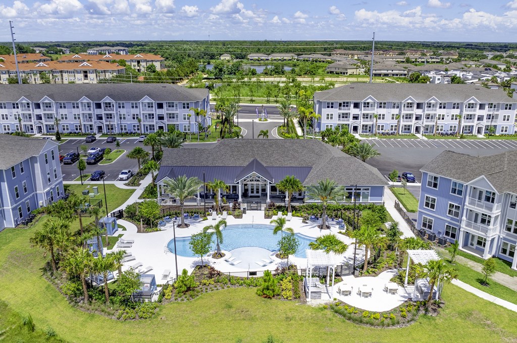 A large resort with a pool and palm trees.