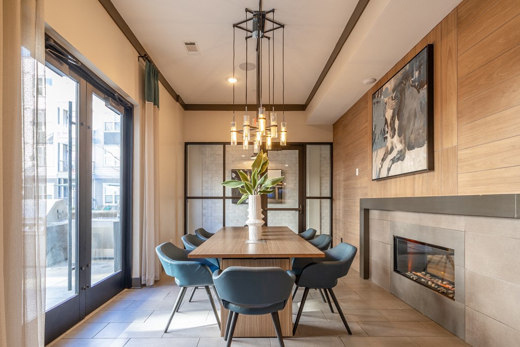 a dining room with a wooden table and chairs and a fireplace