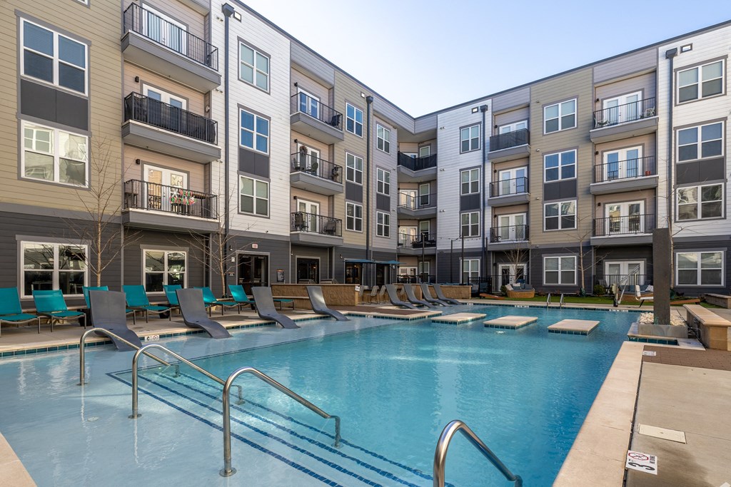 a swimming pool in front of an apartment building