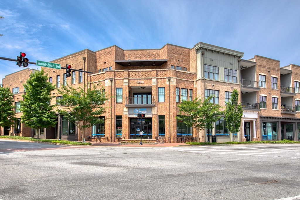a large brick building with a traffic light in front of it